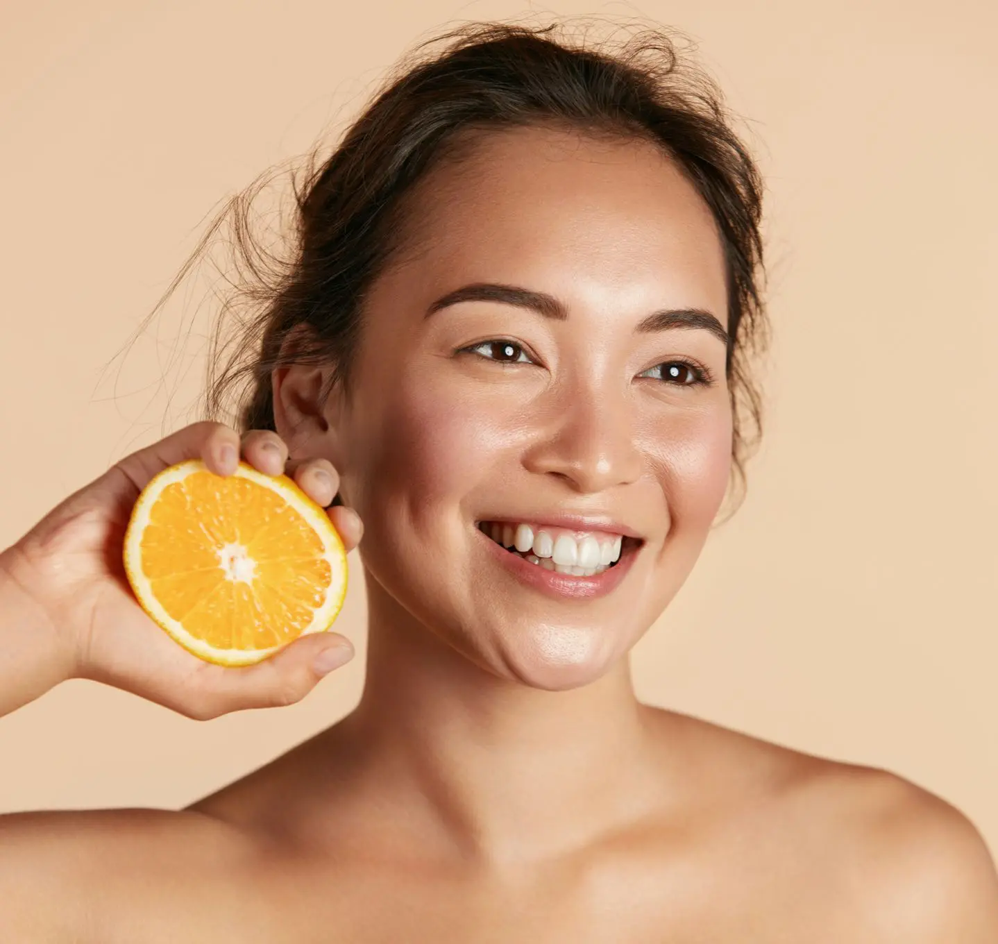 Woman smiling with orange on her hand