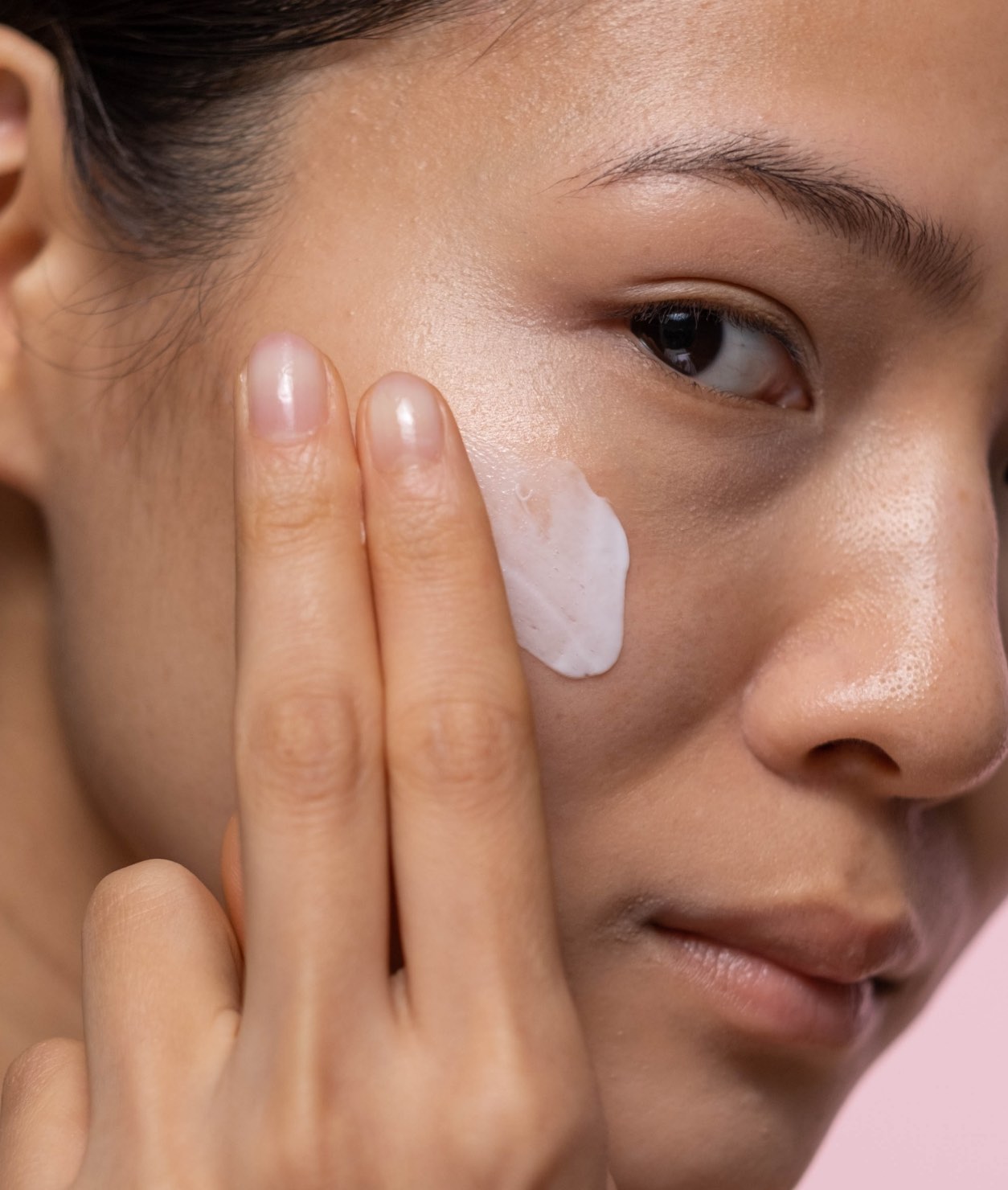 Woman applying facial cream