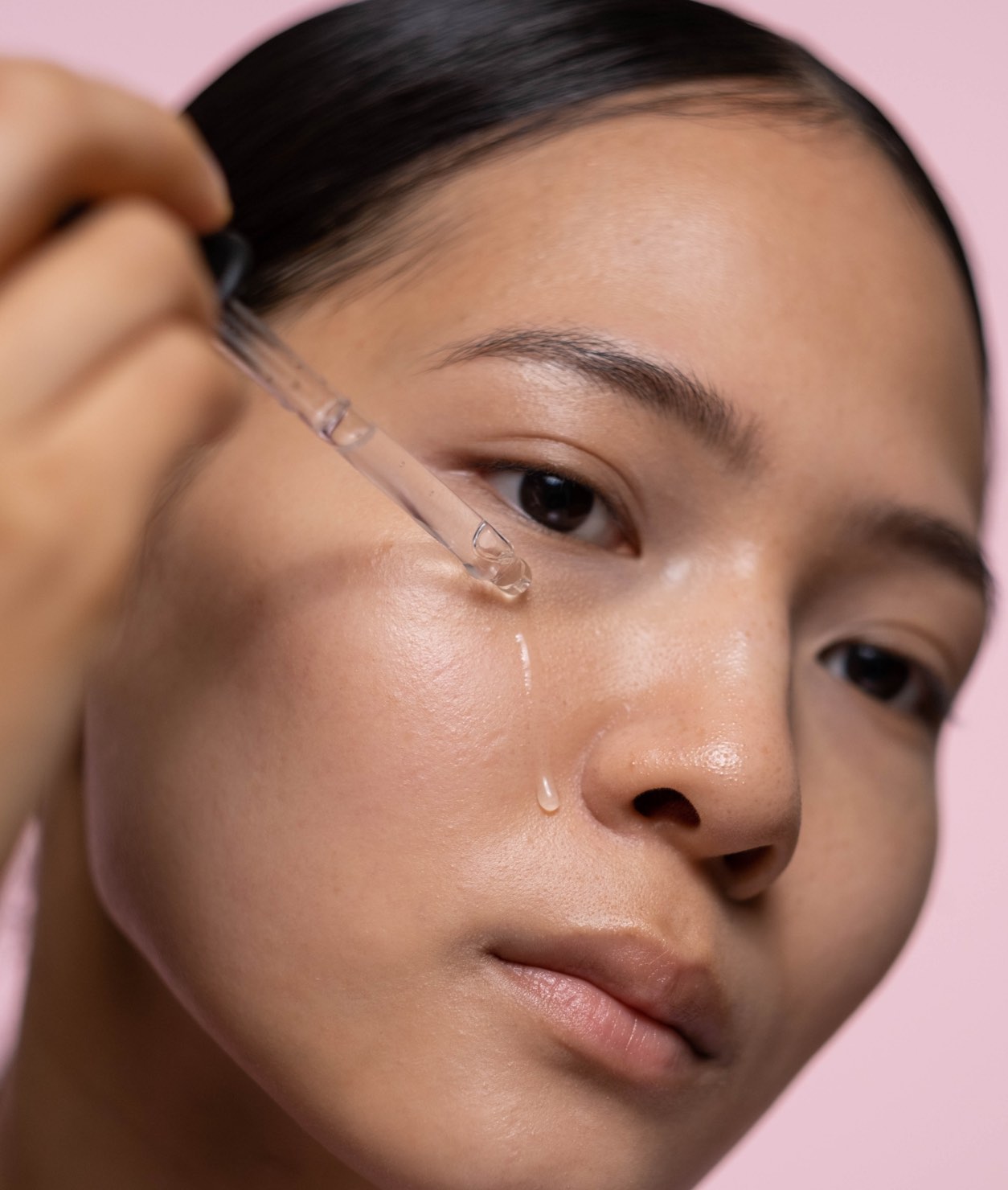 Woman applying serum